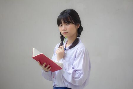 asia thai high school student uniform beautiful girl Write a bookの写真素材