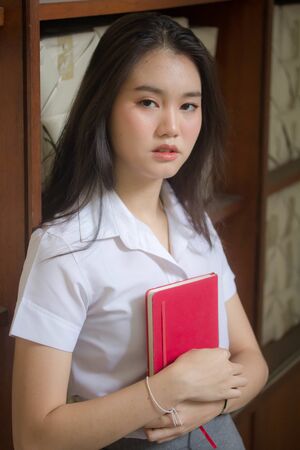 thai adult student university uniform beautiful girl relax and smileの写真素材