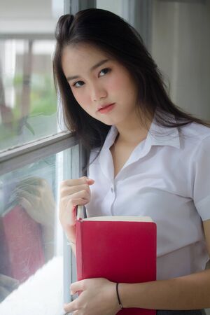 thai adult student university uniform beautiful girl relax and smileの写真素材