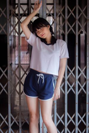 thai teen beautiful girl in japanese sports student uniform happy and relaxの写真素材