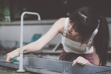 Portrait of thai japanese adult beautiful girl White shirt blue jeans relax time, in Vintage Styleの写真素材