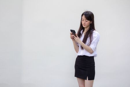 portrait of thai china adult office girl white shirt using her smart phoneの写真素材