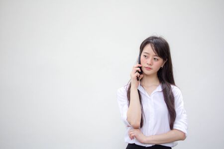 portrait of thai china adult office girl white shirt walk  and calling smart phoneの写真素材