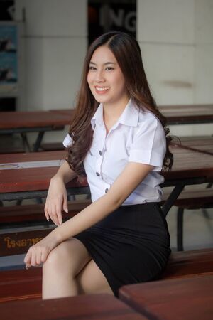 thai adult student university uniform beautiful girl relax and smileの写真素材
