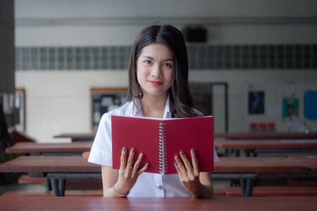 thai adult student university uniform beautiful girl relax and smileの写真素材