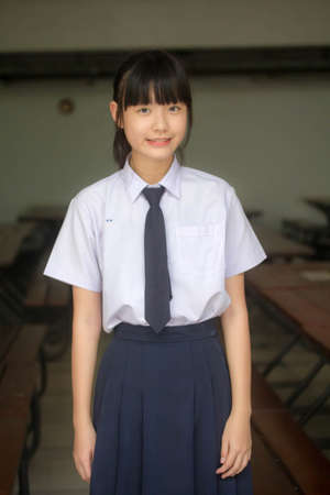 Portrait of thai Junior high school student uniform teen beautiful girl happy and relaxの写真素材