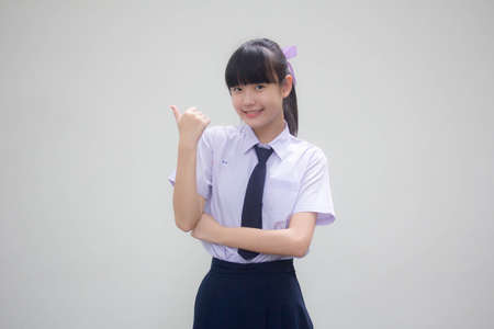 Portrait of thai Junior high school student uniform beautiful girl pointingの写真素材