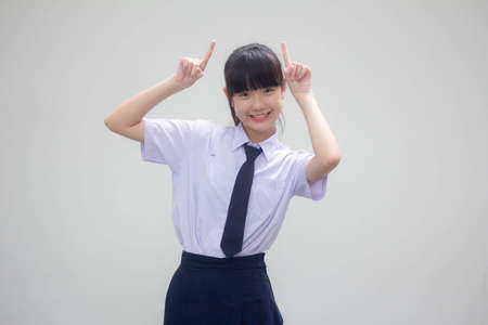 Portrait of thai Junior high school student uniform beautiful girl pointingの写真素材