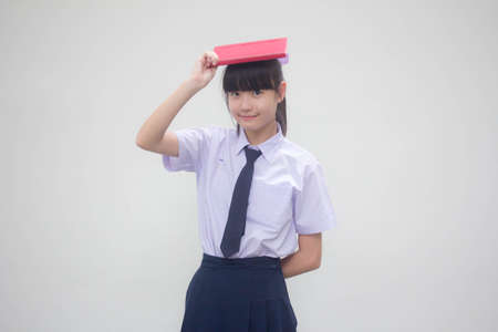asia thai Junior high school student uniform beautiful girl and a bookの写真素材