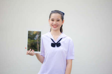 asia thai Junior high school student uniform beautiful girl show her tabletの写真素材