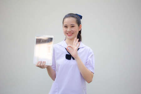 asia thai Junior high school student uniform beautiful girl show her tablet