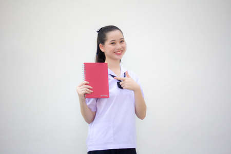 asia thai Junior high school student uniform beautiful girl show a bookの写真素材