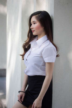 thai adult student university uniform beautiful girl smile and relaxの写真素材