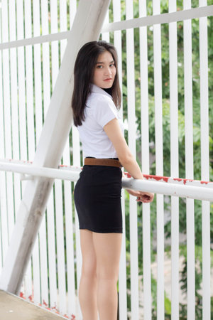 thai adult student university uniform beautiful girl smile and relaxの写真素材