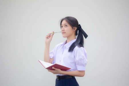 Portrait of thai high school student uniform beautiful girl Thinkの写真素材