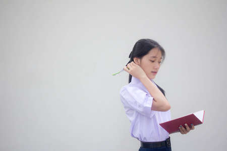 Portrait of thai high school student uniform beautiful girl Thinkの写真素材