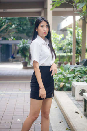 thai adult student university uniform beautiful girl smile and relaxの写真素材