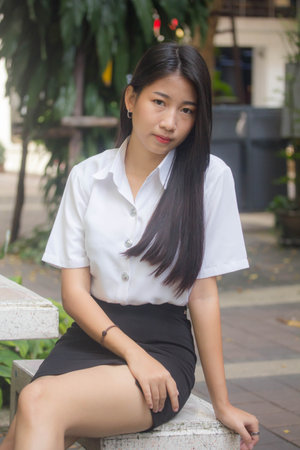 thai adult student university uniform beautiful girl smile and relaxの写真素材