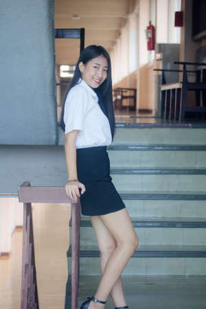 thai adult student university uniform beautiful girl smile and relaxの写真素材