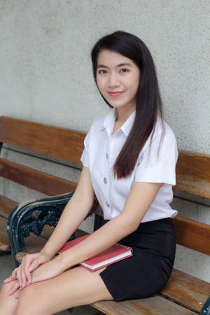 thai adult student university uniform beautiful girl smile and relaxの写真素材