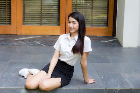 thai adult student university uniform beautiful girl smile and relaxの写真素材