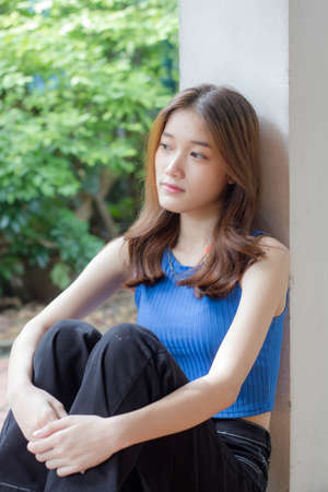 Portrait of thai china adult beautiful girl blue shirt black jeans relax timeの写真素材