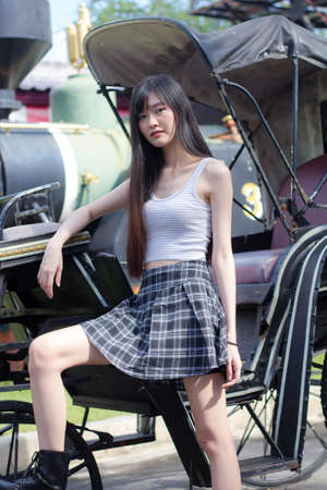 Portrait of japan adult beautiful girl white shirt plaid skirt relax timeの写真素材