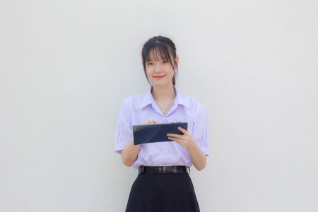 asia thai high school student uniform beautiful girl using her tabletの写真素材