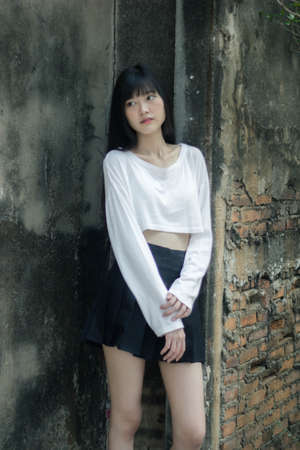 Portrait of thai adult beautiful girl white shirt black skirt relax time