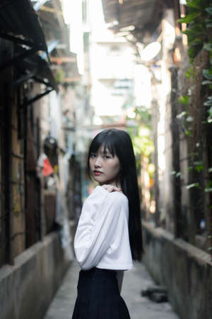 Portrait of thai adult beautiful girl white shirt black skirt relax timeの写真素材