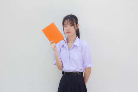 asia thai high school student uniform beautiful girl show a bookの写真素材