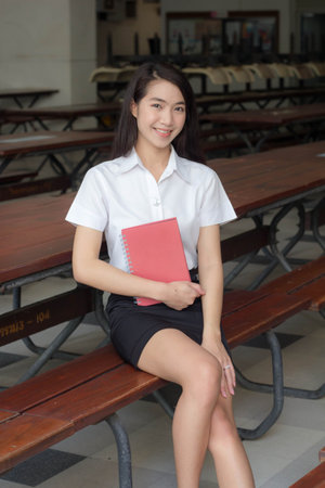 thai adult student university uniform beautiful girl smile and relaxの写真素材