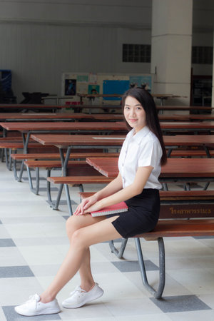 thai adult student university uniform beautiful girl smile and relaxの写真素材