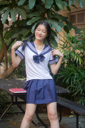 japanese teen beautiful girl in student uniform happy and relaxの写真素材