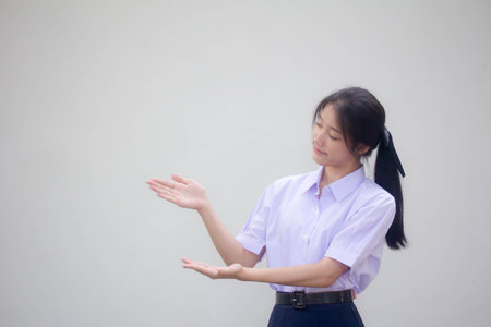asia thai high school student uniform beautiful girl show handの写真素材
