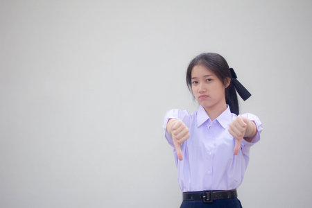 Portrait of thai high school student uniform beautiful girl dislikeの写真素材