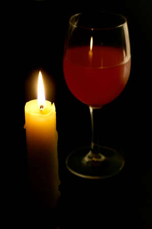 Candle with glass of wine in the backgroundの写真素材