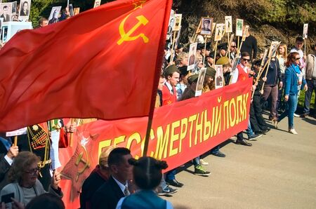 ULYANOVSK, RUSSIA - MAY 9, 2016: Procession of people with flags and photos their relatives in...