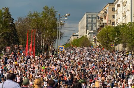 ULYANOVSK, RUSSIA - MAY 9, 2016: Procession of people with flags and photos their relatives in Immortal Regiment on annual Victory Day, May, 9, 2016 in Ulyanovsk city, Russia.のeditorial素材