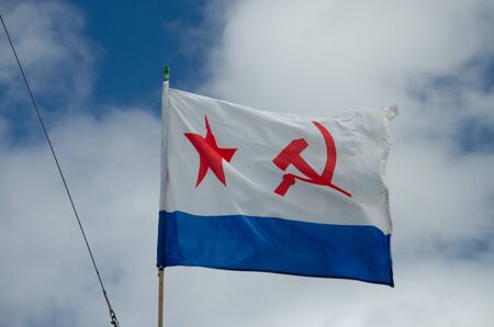 Ulyanovsk, Russia - July 27, 2019. Flag of the Russian Navy against the blue sky with cloudsのeditorial素材