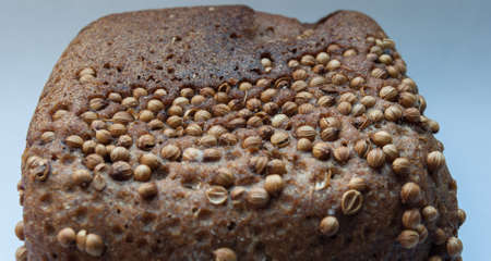 Closeup of fresh bread with nuts on blue background
