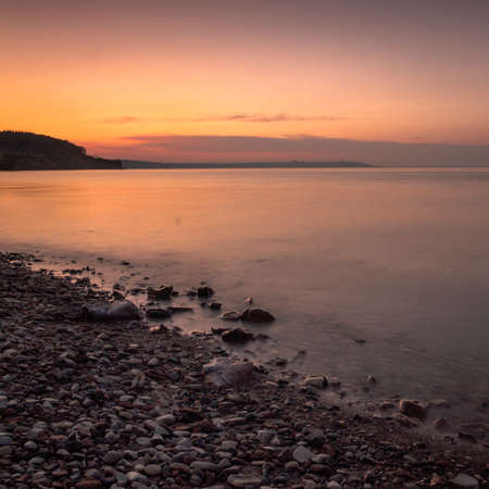Shore at sunset. Long shutter speed.の写真素材