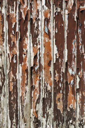 Fragment of a wooden fence with cracked paintの写真素材