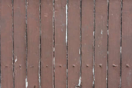 Fragment of a wooden fence with cracked paintの写真素材