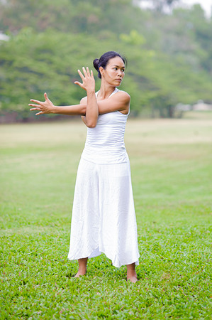 Beautiful woman practicing yoga in the park.Shoulder Stretch.の写真素材