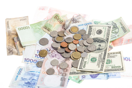 Several bank notes of american singapore indonesian thai korean and coins isolate on white backgroundの写真素材
