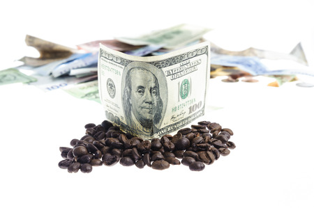 Coffee bean with Several bank notes of american singapore indonesian thai korean and coins isolate on white backgroundの写真素材