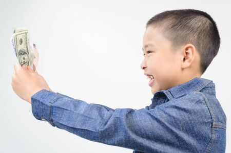 Young boy with happy and smile with american and korean bank noteの写真素材