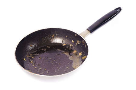 Dirty used iron pan after cook on white backgroundの写真素材