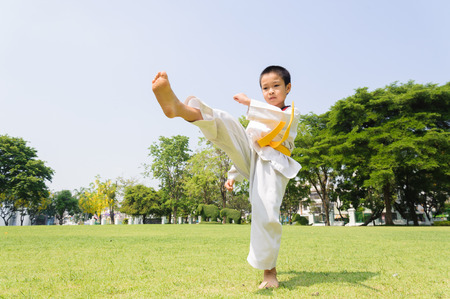 Boy practice taekwondo in the park during dayの写真素材